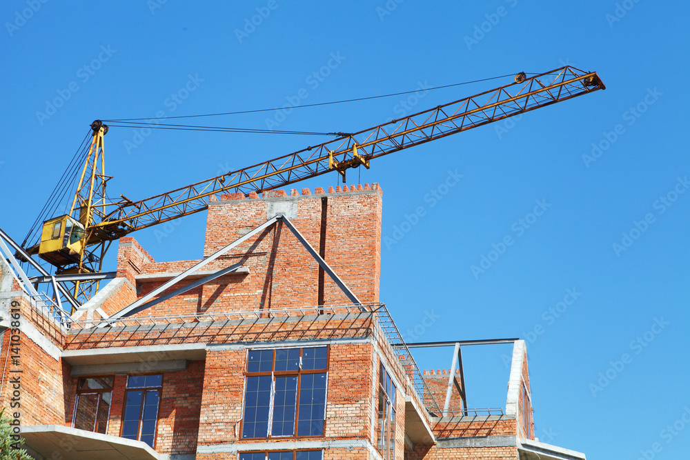Building crane and building under construction Building crane and building under construction