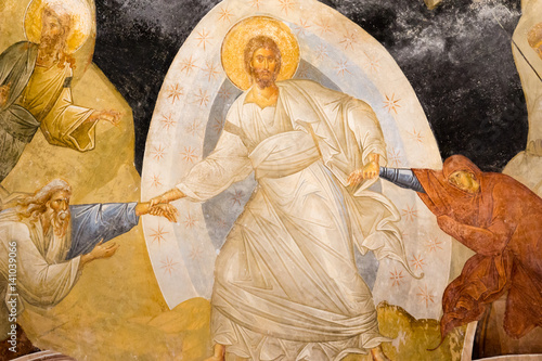 Christ standing in a mandorla, pulling Adam and Eve from the underworld, an old fresco of the resurrection, the anastasis in Chora church.  photo