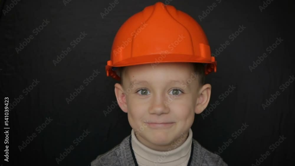 Boy in a construction helmet.Full hd video Boy in a construction helmet.Full hd video