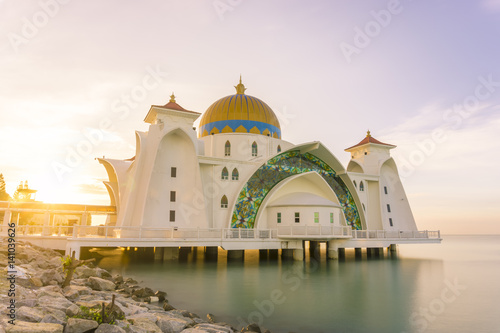 A mosque in Malacca, Malaysia that built near seascape, sunrise with colorful sky 