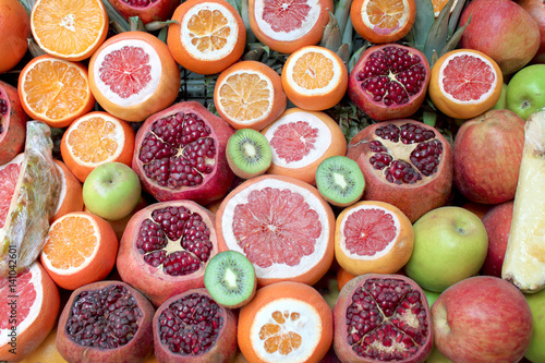 Background pattern of different fruits: pomegranate, kiwi, orange, grapefruit