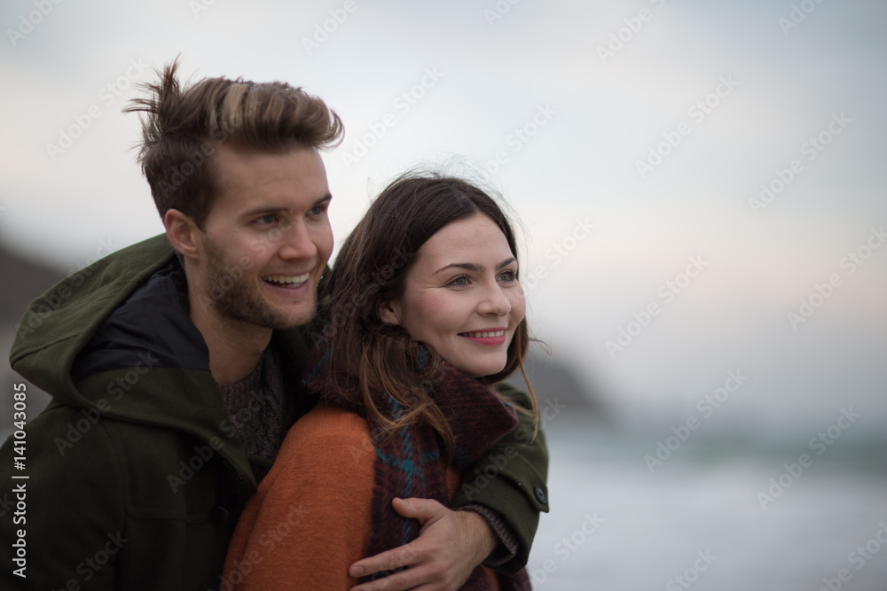 Young adult couple hugging on beach Young adult couple hugging on beach