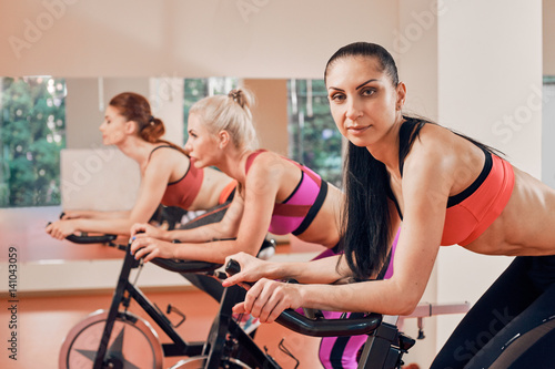 fitness young woman portrait on exercise bikes