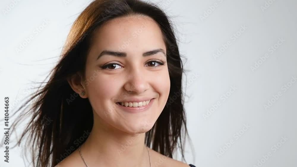 A lovely teenage girl with beautiful streaming long hair smiles sincerely A lovely teenage girl with beautiful streaming long hair smiles sincerely