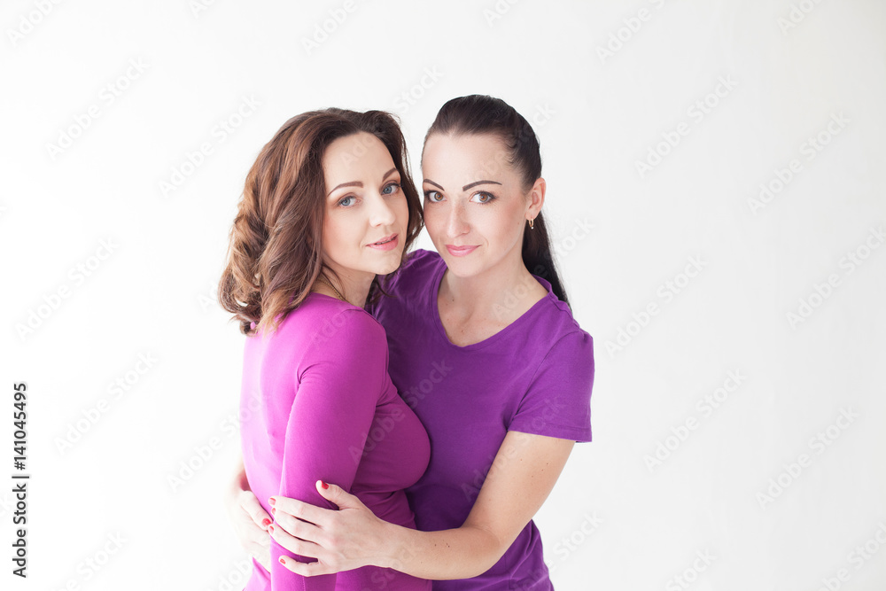 women stand together in purple women stand together in purple