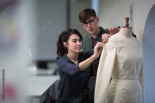 Fashion students working on a design together photo