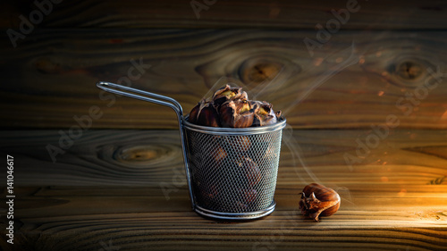 Roasted chestnuts in steel basket