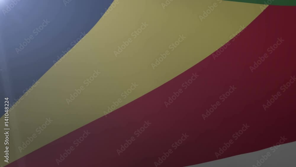 Flag of Seychelles waving on flagpole in the wind, national symbol of freedom Flag of Seychelles waving on flagpole in the wind, national symbol of freedom