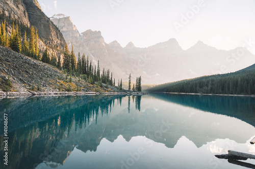Reflection of mountain peaks on turquoise river photo