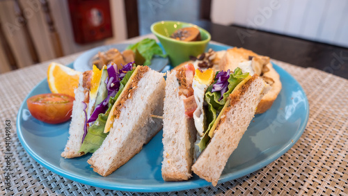 Closeup club sandwich on blue dish 1