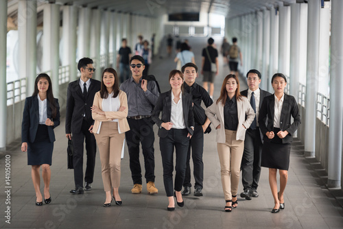 Portrait of a confident business team standing together in walk way to office