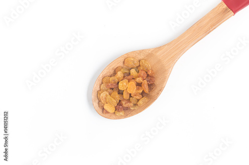 Raisins. Dried Grapes into a spoon