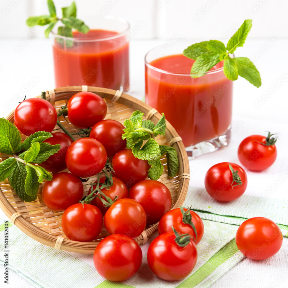 Fresh vegetables tomato, pepper, greens and tomato juice close-up on a light background Fresh vegetables tomato, pepper, greens and tomato juice close-up on a light background