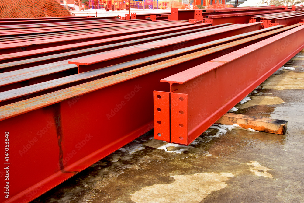 Rows of steel I beams ready for installation at nearby construction