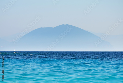 mountain and ocean landscape blue silhouette of peaks.