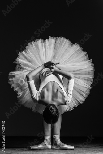 Young beautiful ballerina posing in studio