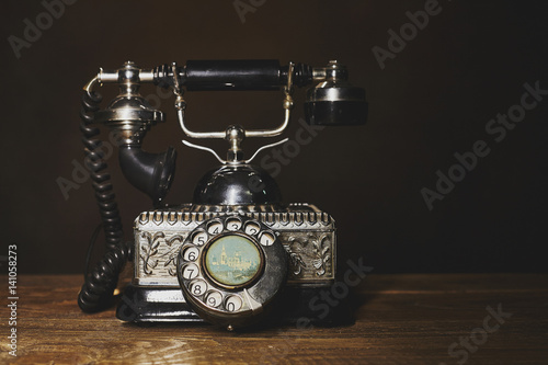 Vintage telephone on wooden table.