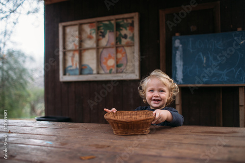 Smiling child holding basket looking at camera