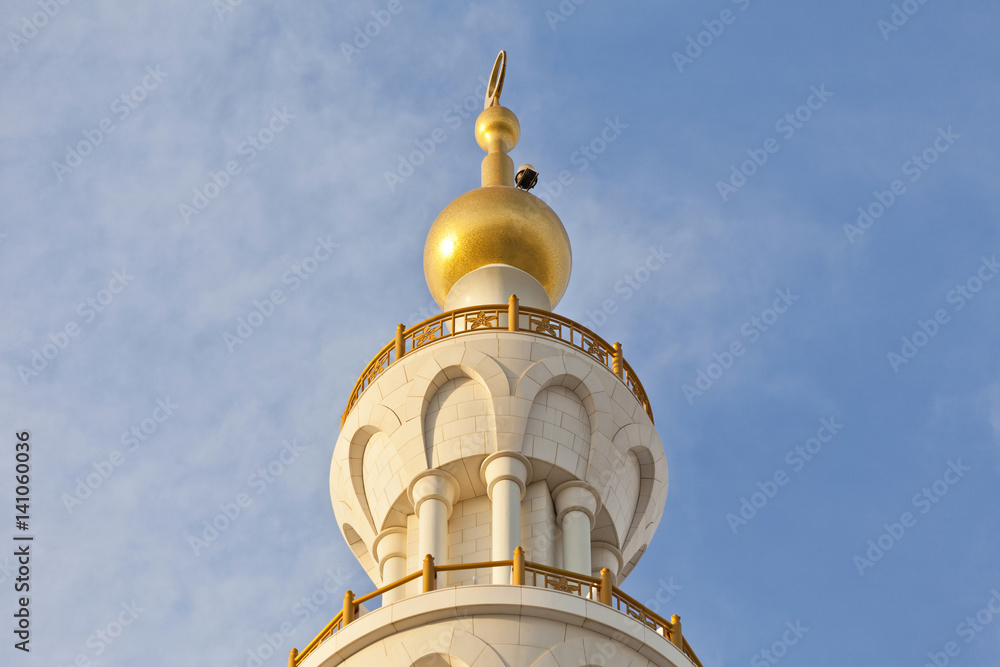 Minaret of the mosque against blue skies Minaret of the mosque against blue skies