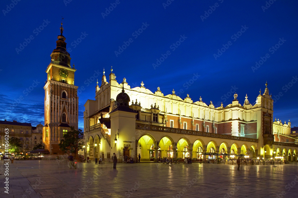 Town Hall Tower and Cloth Hall (Sukiennice) in Main Market Square (Rynek Glowny) in Krakow by Night, Poland, Europe.