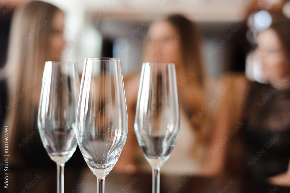 empty glasses of champagne on the background of the girls empty glasses of champagne on the background of the girls