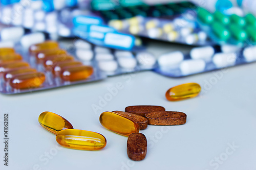 Background of assorted pharmaceutical capsules and medication in different colors. photo