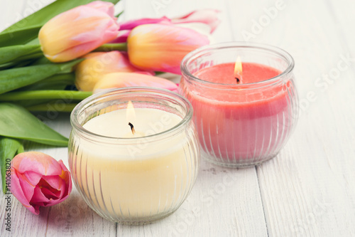 Yellow and pink aroma candles with tulips