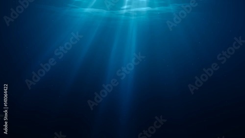 Sunlight rays shining through ocean surface. View from underwater. 3D rendered seamless loop animation. photo