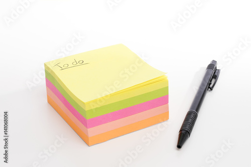 Post-it stack on seamless white background with black pen