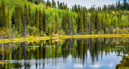 Float planes on Alaska wilderness lake with reflections in the lake