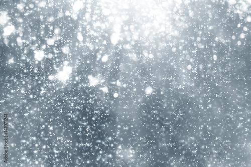 Snowflakes rays and bokeh or glitter lights on silver background. Christmas abstract template