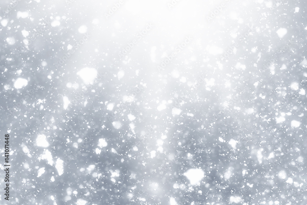 Snowflakes rays and bokeh or glitter lights on silver background. Christmas abstract template