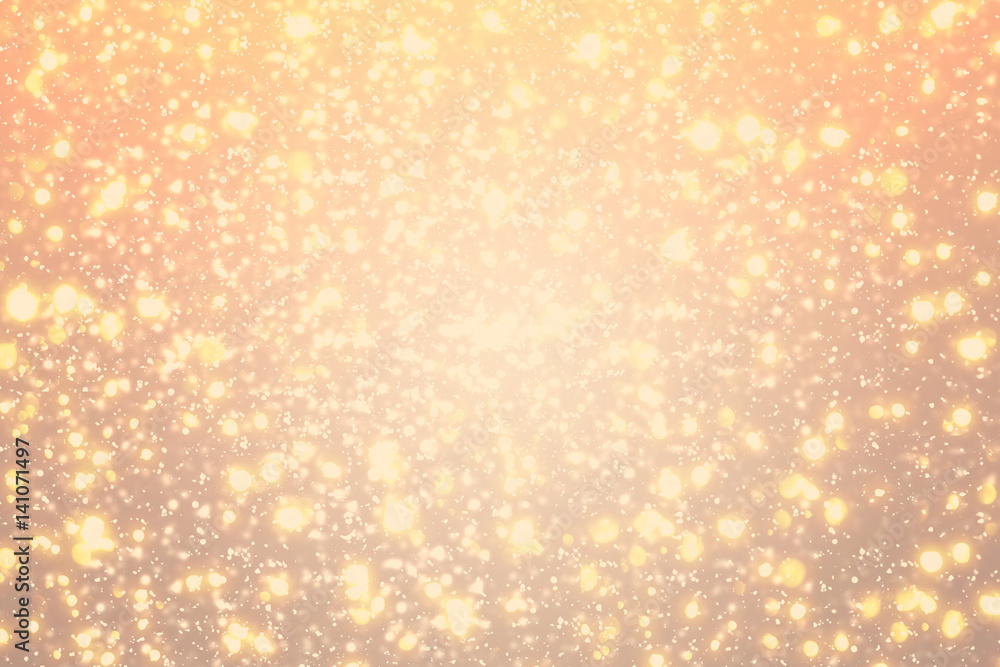Golden rays and sparkles or glitter lights. Merry Christmas festive gold background.defocused circle bokeh or particles