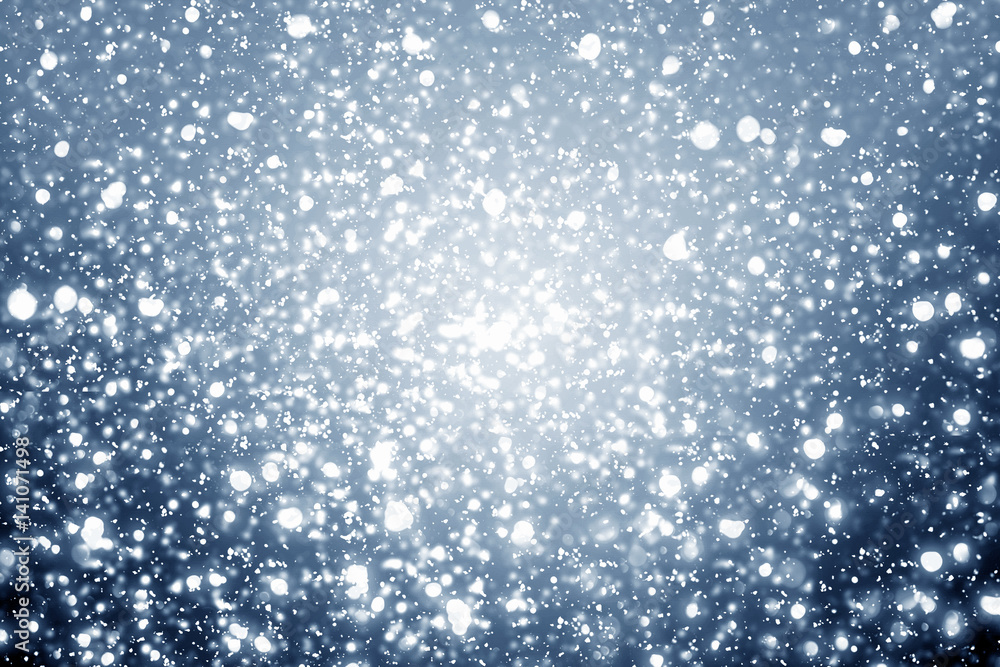Fototapeta premium Snowflakes particles and bokeh or glitter lights on silver background. Christmas abstract template
