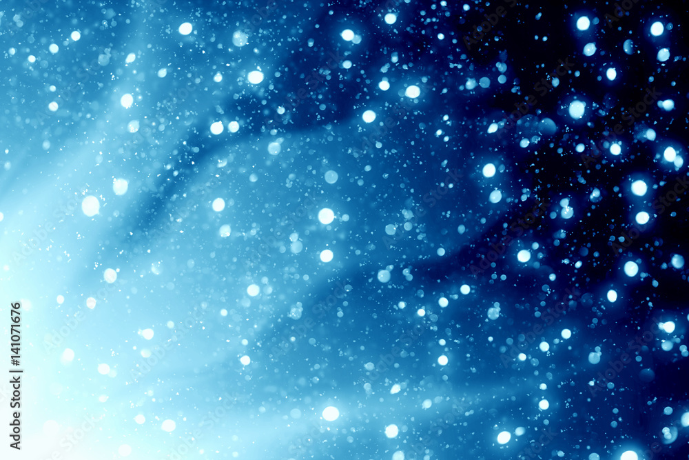 Abstract bokeh glitter lights and rays on blue background. Round defocused circle particles. Christmas template Abstract bokeh glitter lights and rays on blue background. Round defocused circle particles. Christmas template