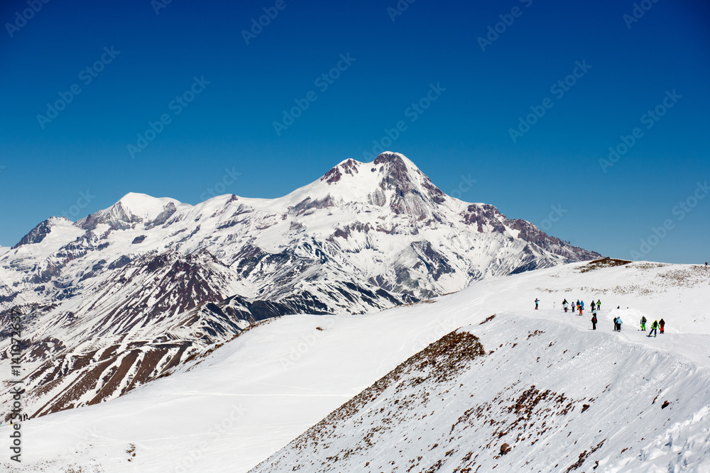 View on ski slope and beautiful mountains in evening. Ski resort Gudauri, Caucasus Mountains, Georgia