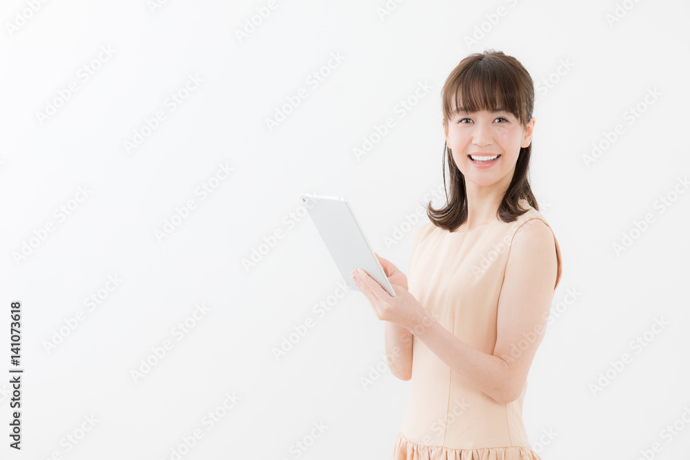 portrait of attractive asian woman using tablet isolated on white background portrait of attractive asian woman using tablet isolated on white background