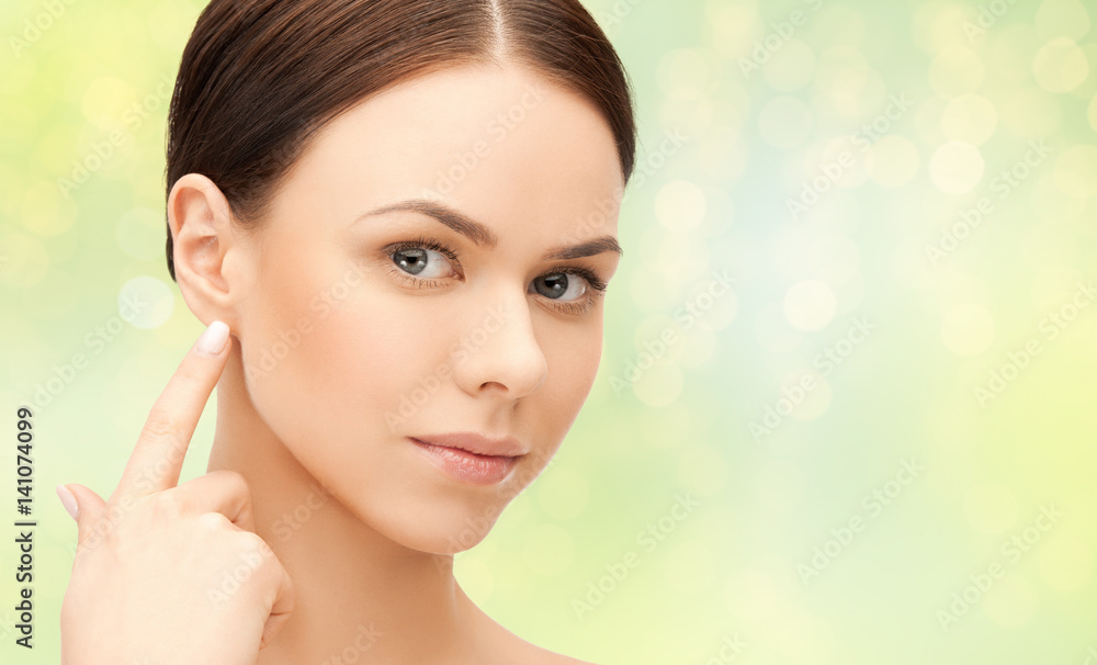 close up of beautiful young woman face over green close up of beautiful young woman face over green