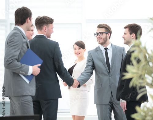 business team meets investors at the office.a friendly handshake