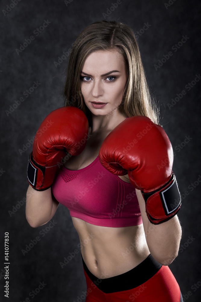 Pretty boxing girl in red box gloves