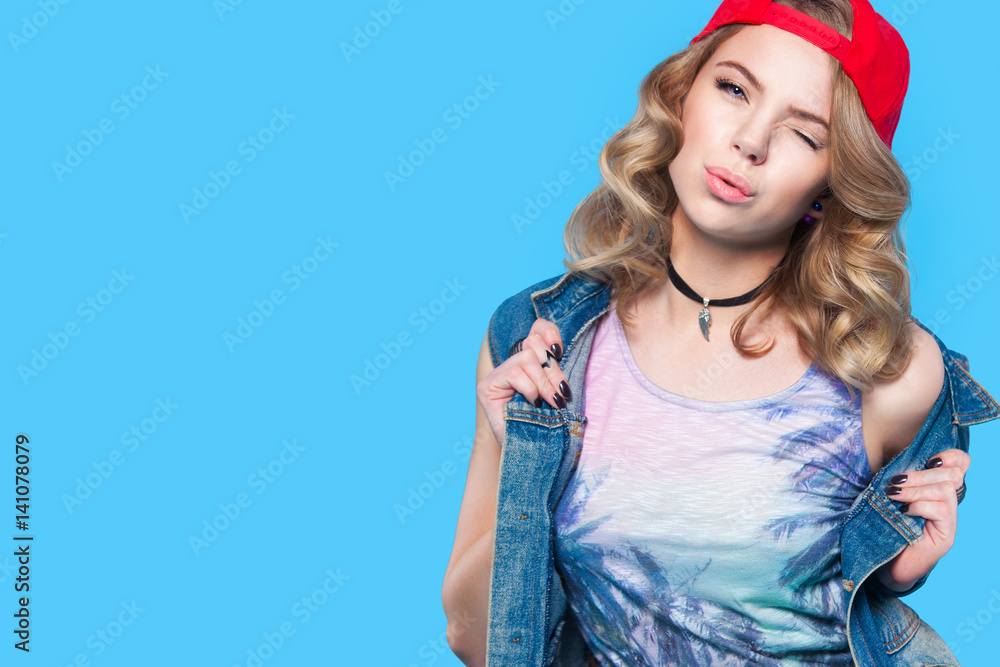 young pretty teenager girl emotional posing on blue background, fashion lifestyle people concept young pretty teenager girl emotional posing on blue background, fashion lifestyle people concept