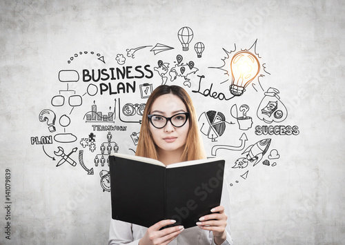 Woman with book and a business plan
