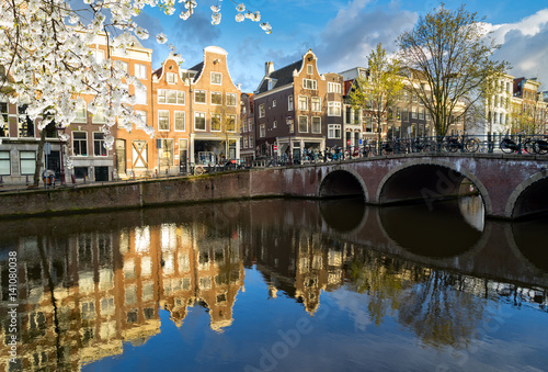 Fototapeta Naklejka Na Ścianę i Meble -  Dutch scenery with canal and mirror reflections at blooming spring, Amstardam, Netherlands