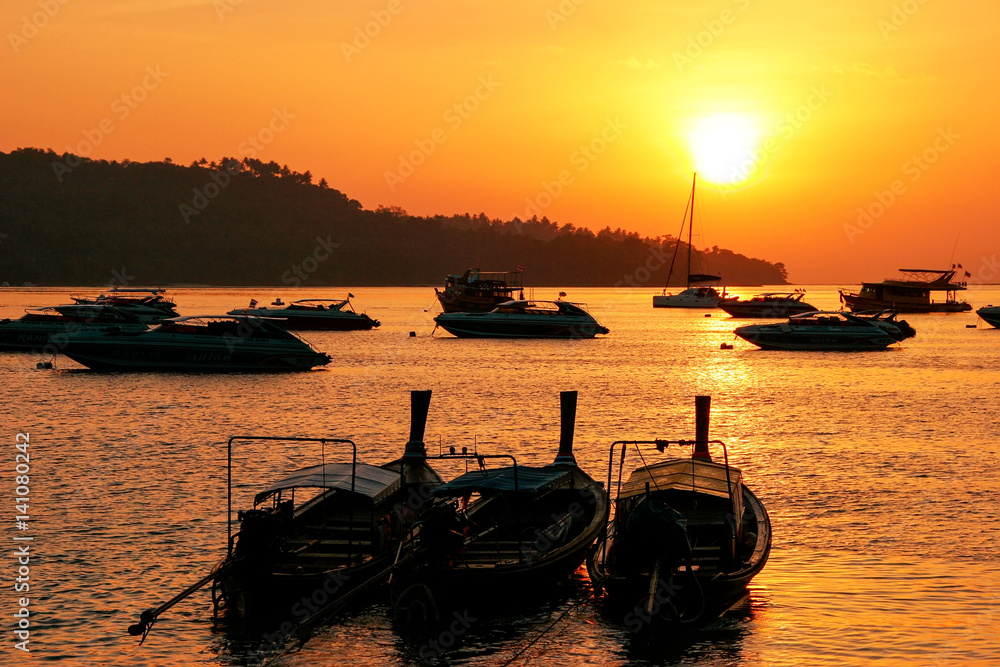 Silhouetted longtail boats at sunrise on Ao Ton Sai, Phi Phi Don Island, Krabi Province, Thailand