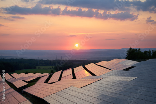 Obraz na płótnie Sunset over solar power station in countryside. View from above. w salonie