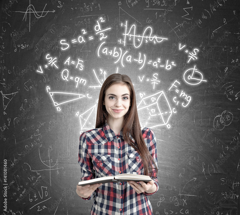 Girl with open book near formulas on blackboard Girl with open book near formulas on blackboard