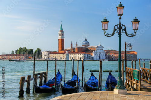 Gondolas moored near San Marco square across from San Giorgio Maggiore island in Venice, Italy © donyanedomam