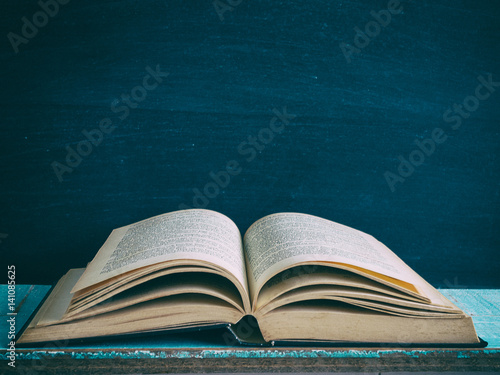 old book open on a wooden table