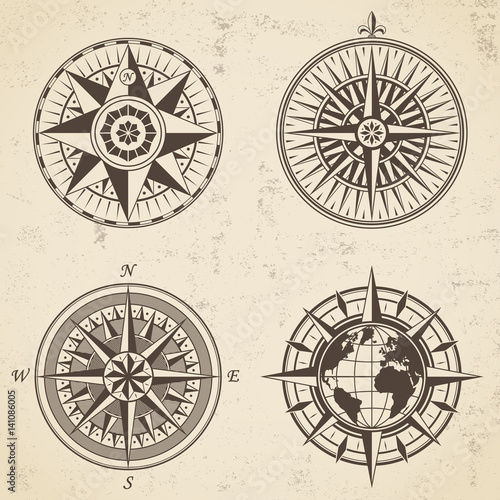 Set of vintage antique wind rose nautical compass signs labels emblems elements.
