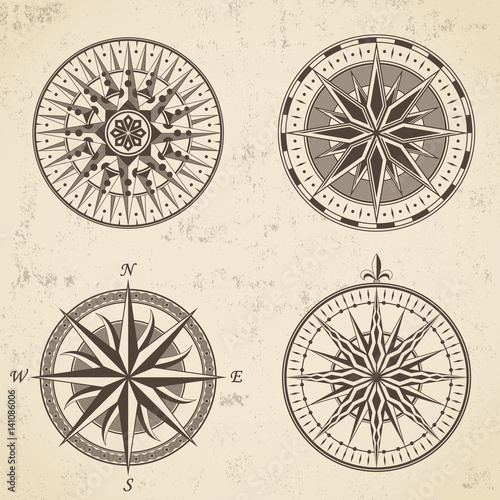 Set of vintage antique wind rose nautical compass signs labels emblems elements.